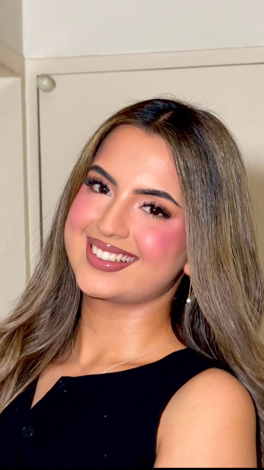 Soft glam evening look on a woman in a black top