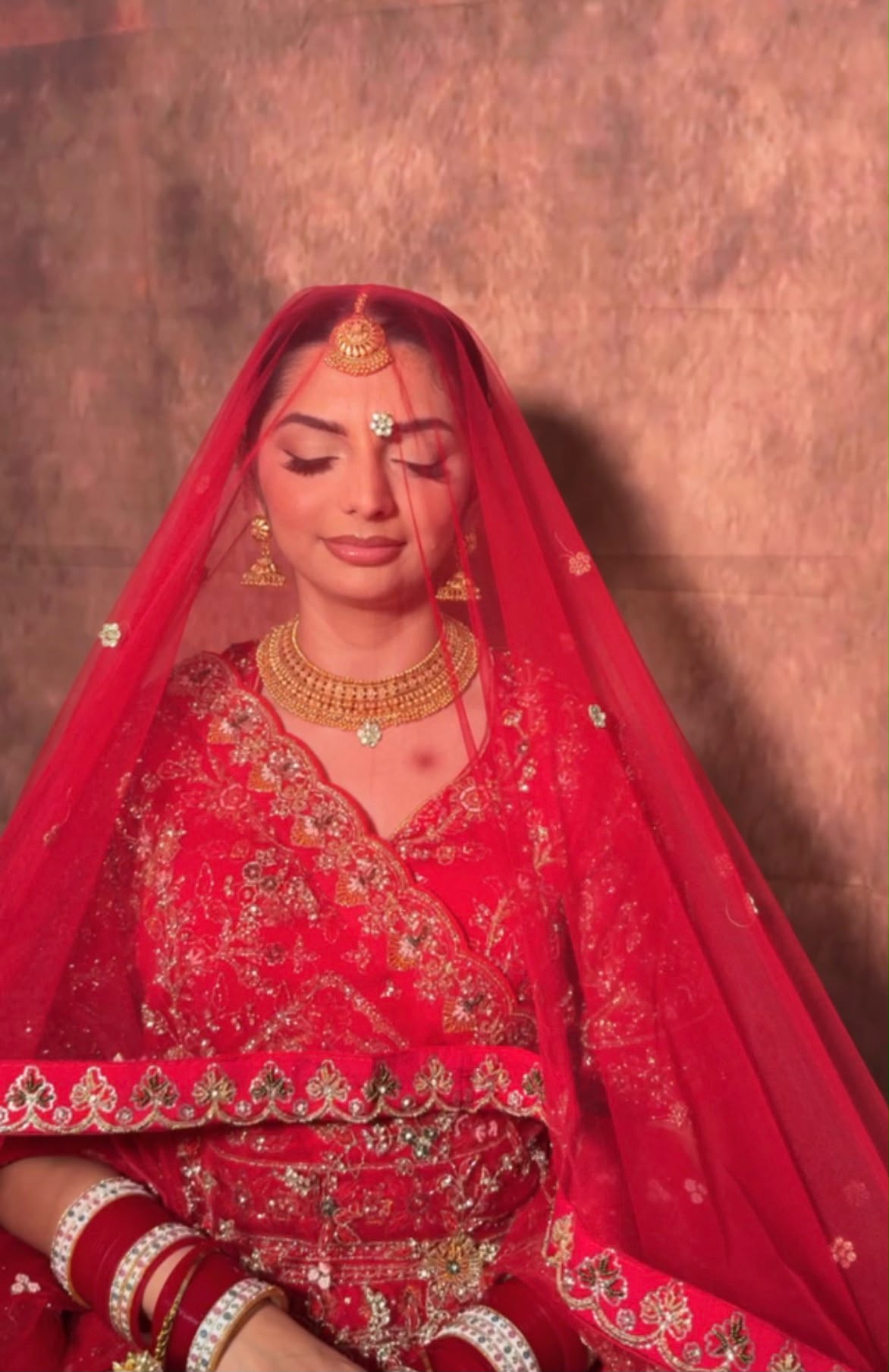 Bride in red lehenga and veil
