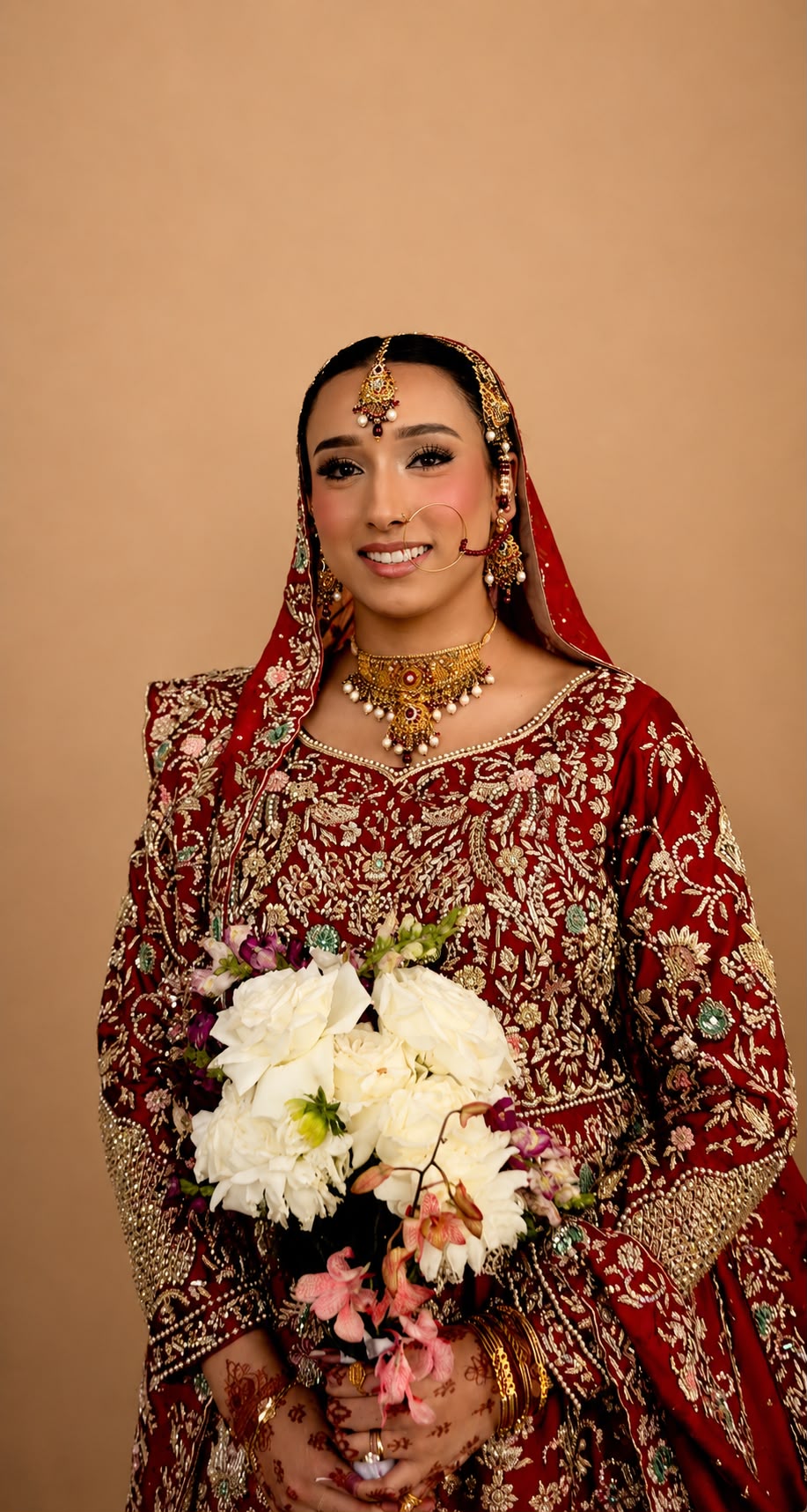 Maroon bridal holding white bouquet